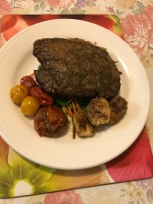 Orange rosemary rump with roasted cherries and Brussel sprouts on a bed of mixed salads.JPG
